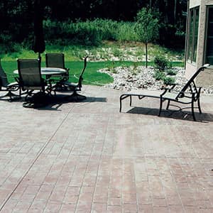 Custom stamped concrete patio with seating at a Twin Cities home
